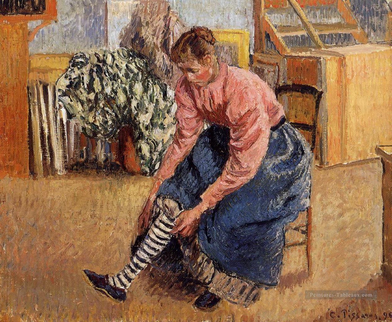 femme mettant ses bas 1895 Camille Pissarro Peintures à l'huile